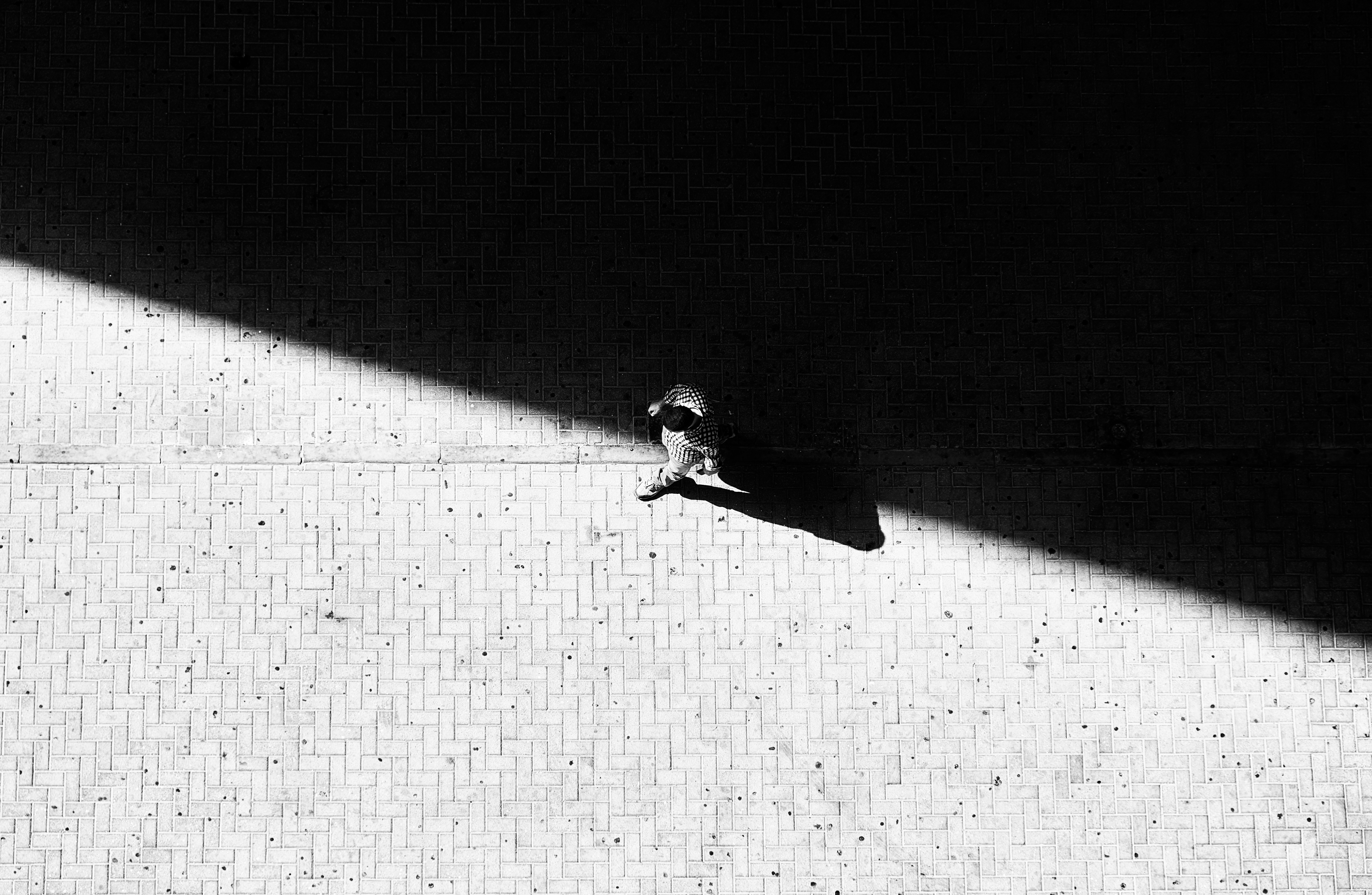 man walking through concrete street